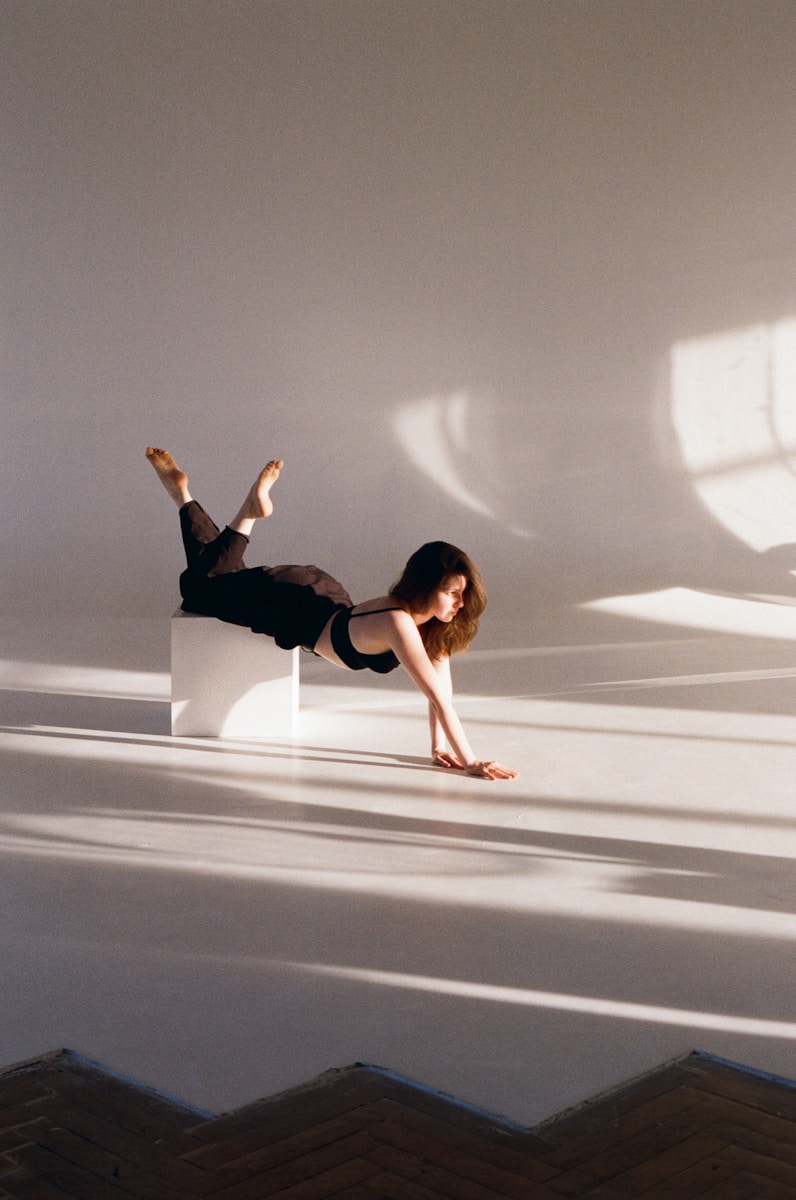 A woman laying on top of a white box