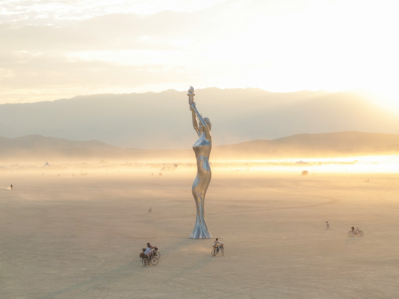 A statue of a woman in the middle of a desert